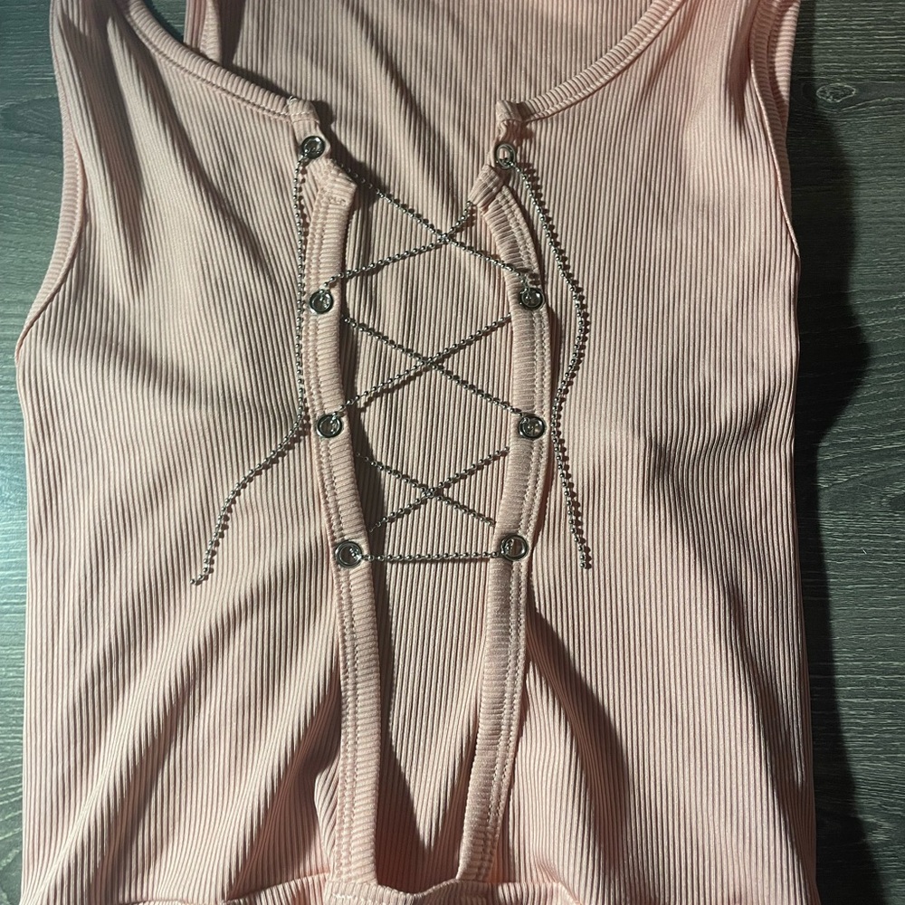 Light pink body suit.